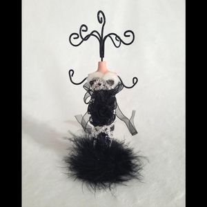 Jewelry stand/holder on porcelain manican with detailed black dress 7 prongs.